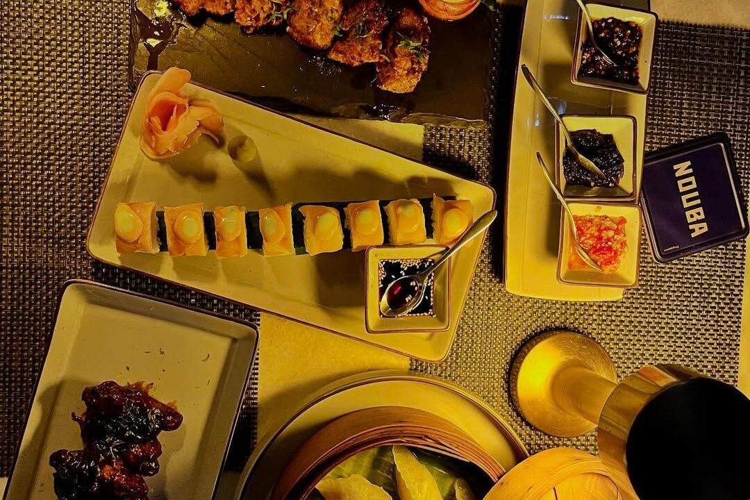 Overhead platters on a yellow table at nouba jaipur
