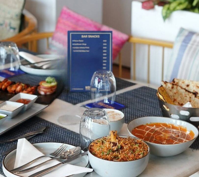 Rooftop table set with the menu card at nouba jaipur