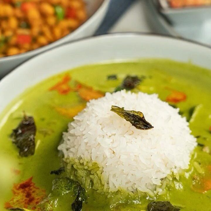 Green curry with steamed rice at nouba jaipur