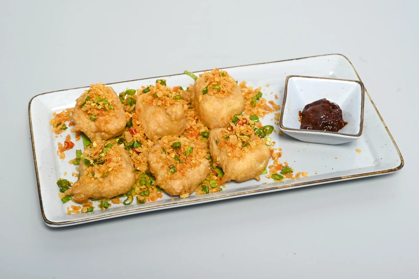 Crispy fried dumplings with spicy dipping sauce