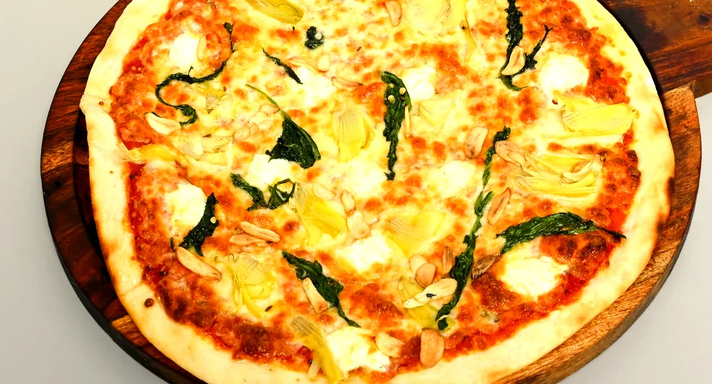 Vegetarian wood-fired pizza with spinach, artichoke and ricotta at Nouba Restaurant Jaipur